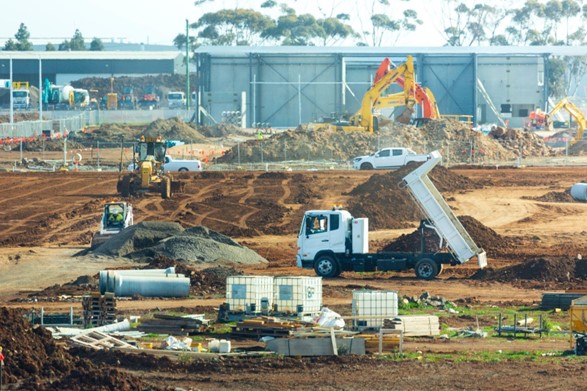 A heavy construction site with trucks and excavators