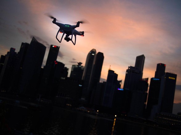 a drone in flight photographing a city