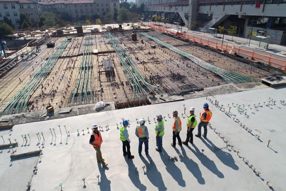 A group of construction workers standing on a roof