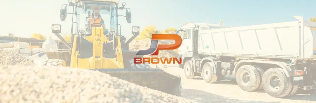 J.P. Brown LLC construction site with excavator and dump truck, representing time savings and bid accuracy improvements using Estimating Link software