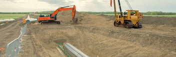 excavator digging and moving dirt on a construction site
