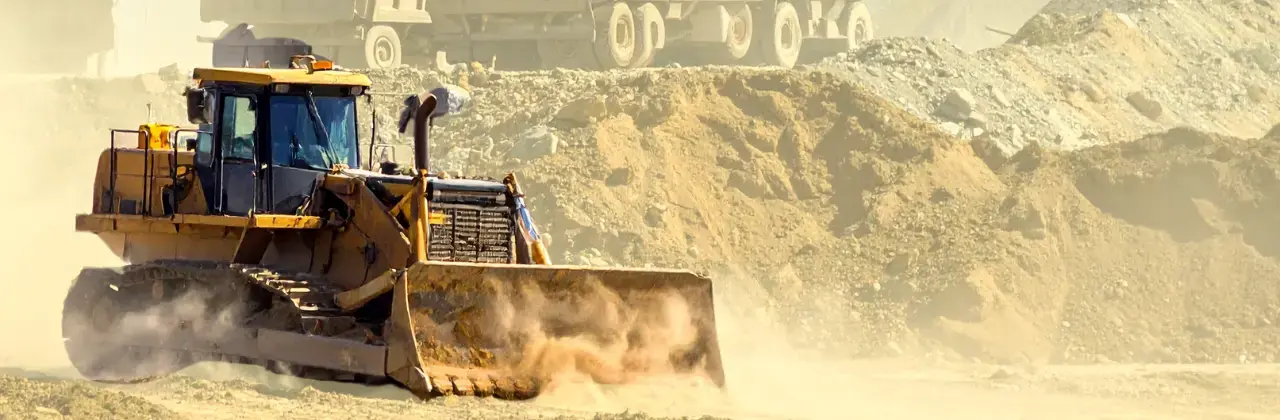 a piece of heavy equipment moving dirt on a construction job site
